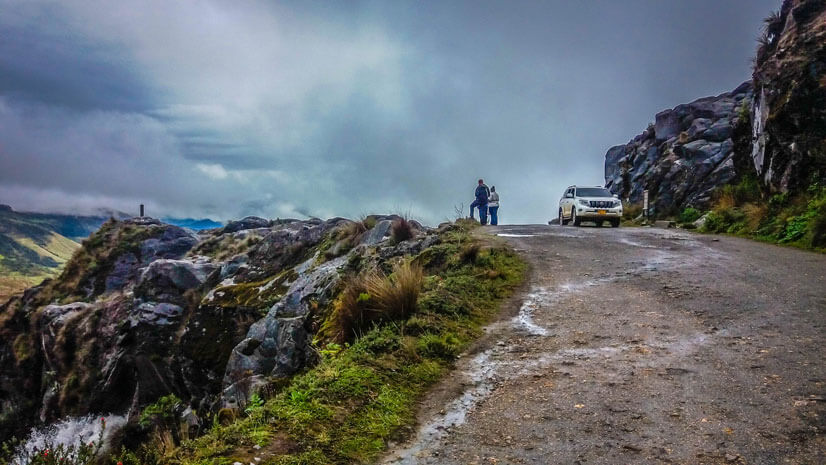 couple standing by high mountain road Colombia multi day tour