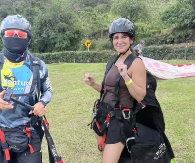 Woman and paragliding pilot geared up and ready to launch in Medellín — unique things to do in Medellín