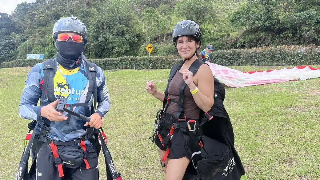 Woman and paragliding pilot geared up and ready to launch in Medellín — unique things to do in Medellín