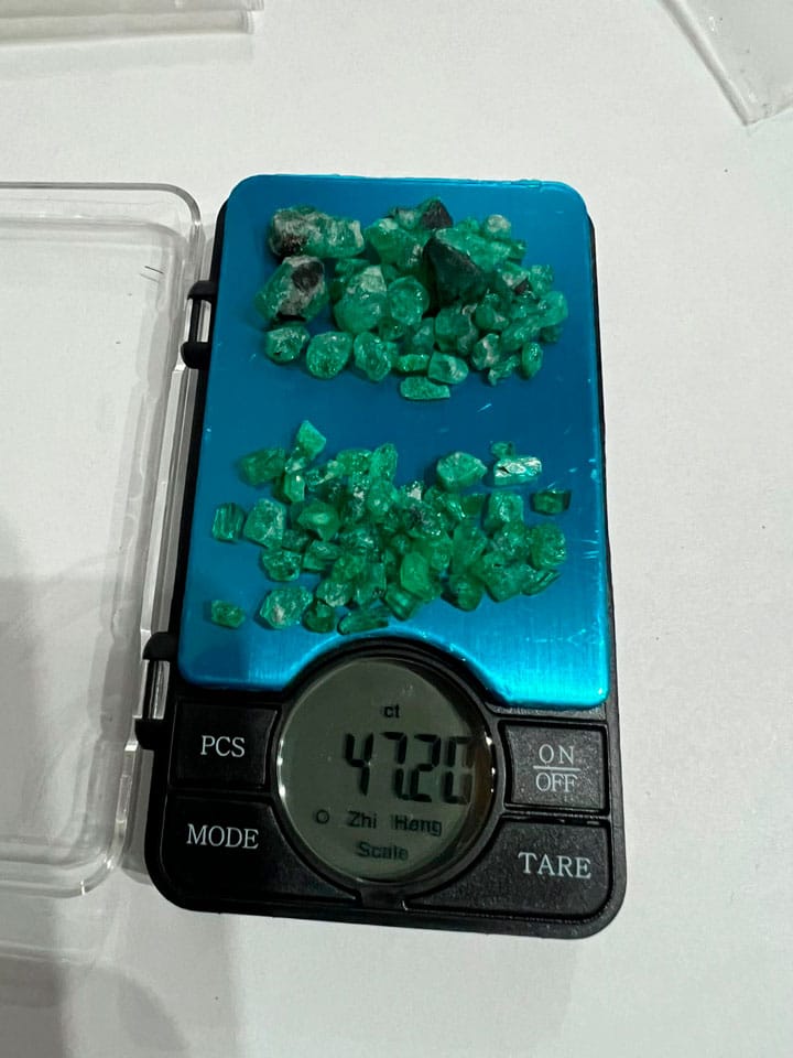 Colombian emeralds on a scale