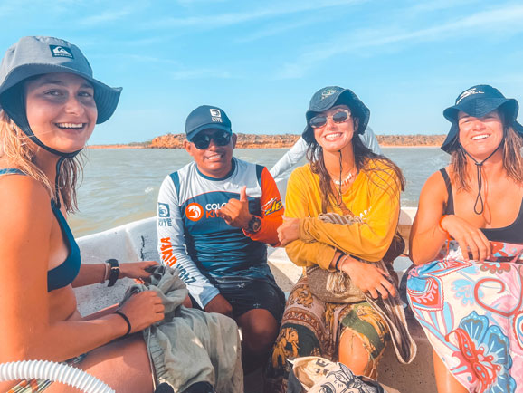 3 girls and 1 instructor on a boat kitesurfing Colombia