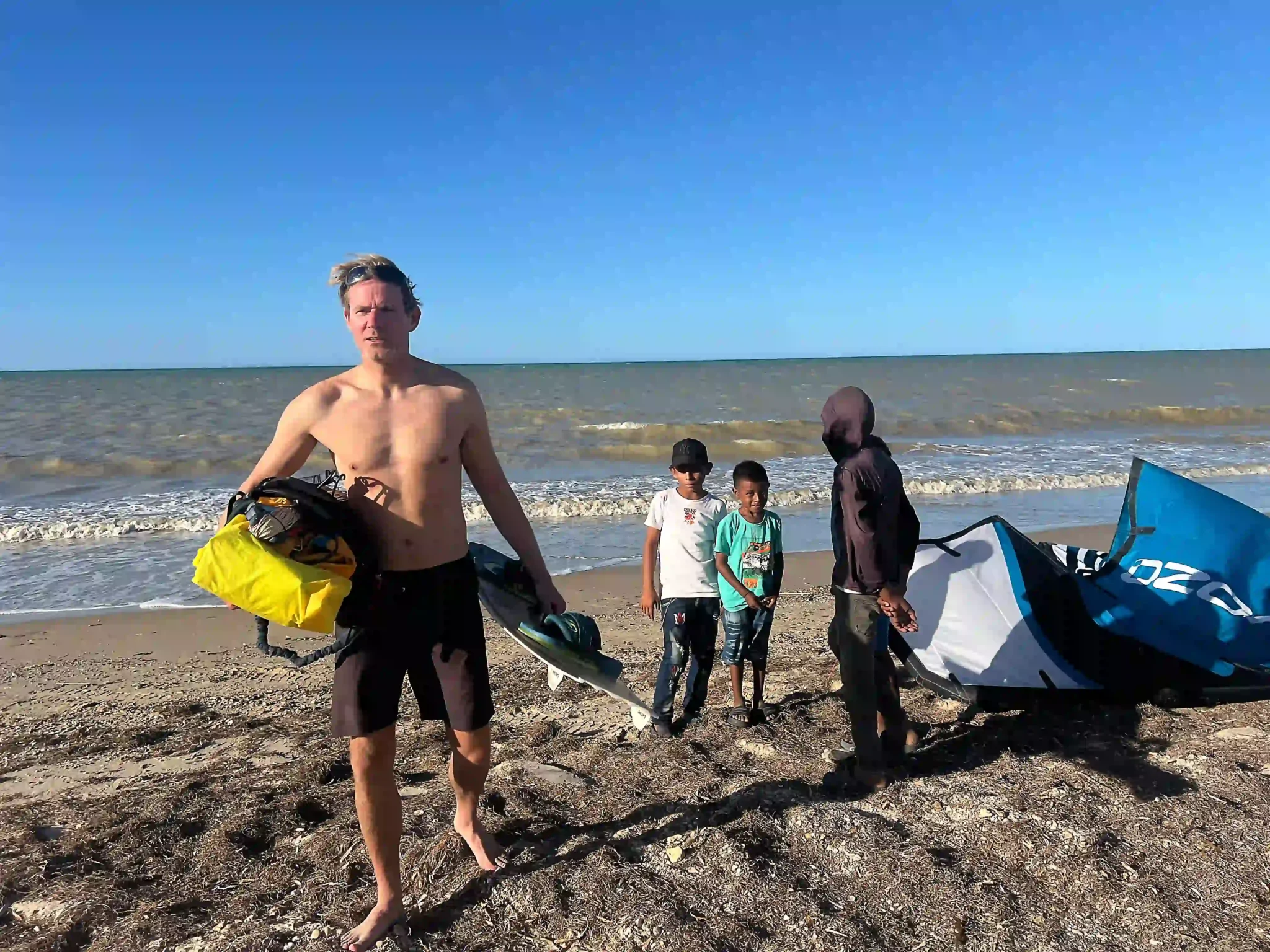 kitesurfer walking on the beach during a kite trip in Colombia