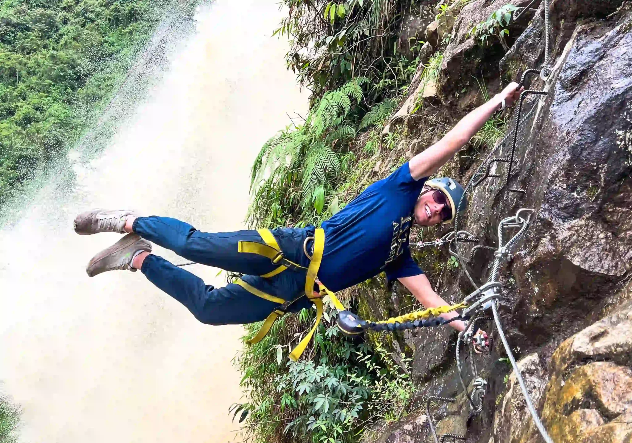 Young man hanging during zipline Medellin tour