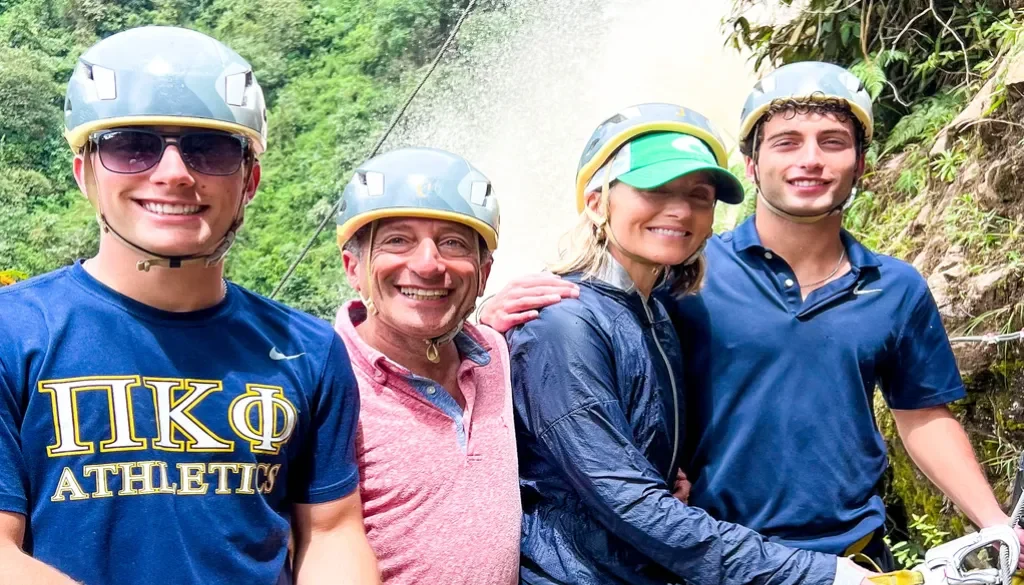 family rock climbing during a day trips medellin