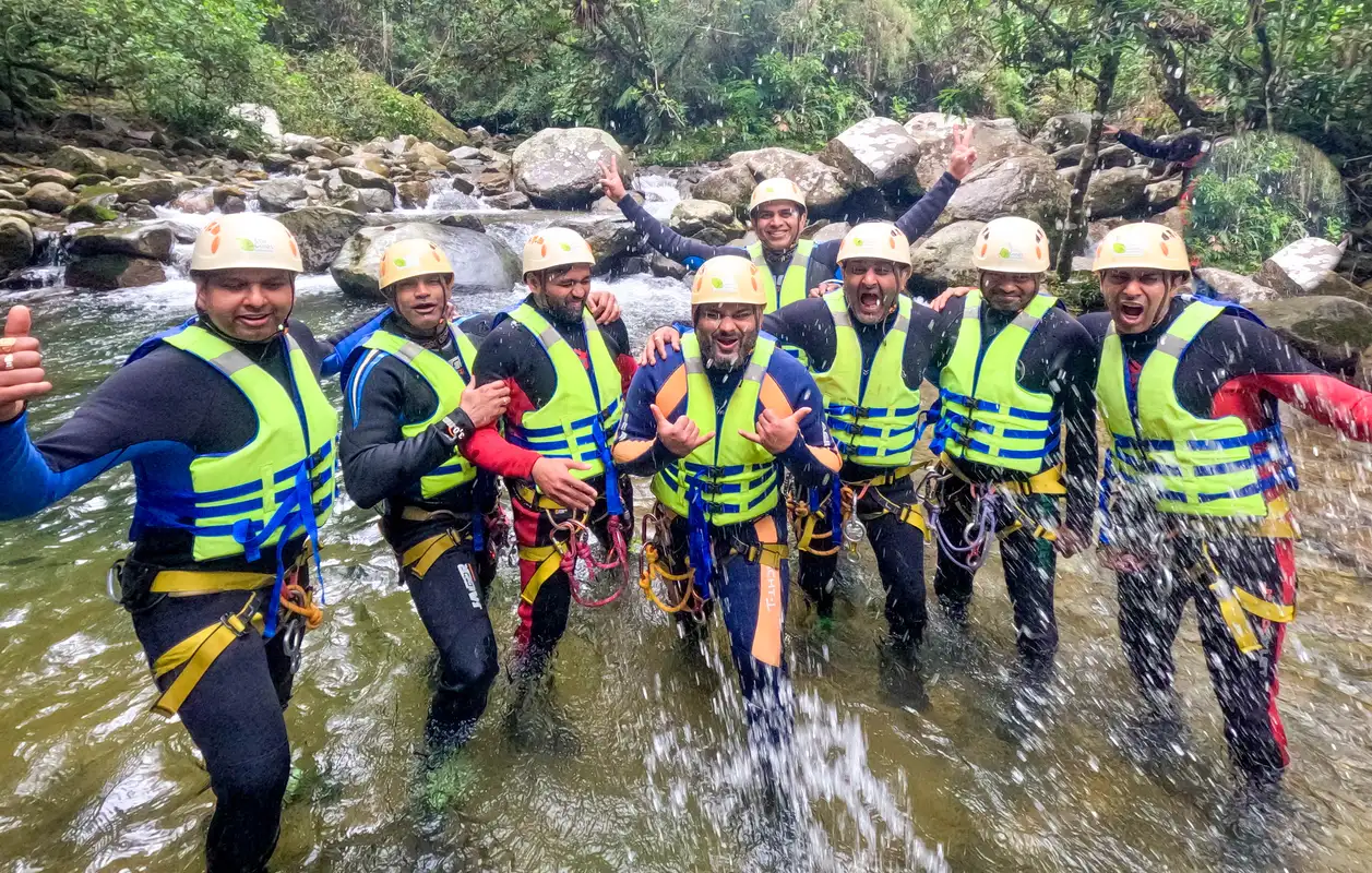 Large group of friends having fun while canyoning unique things to do in Medellin
