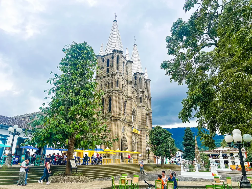 Church in central plaza of small town during coffee region tour from Medellin