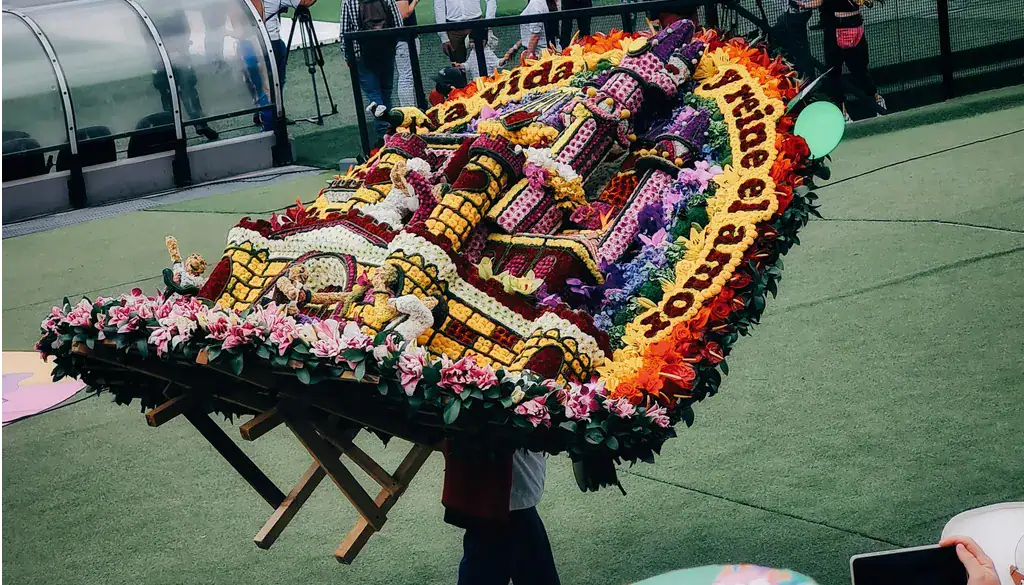 Medellin Flower Festival silletero carrying flowers on his back